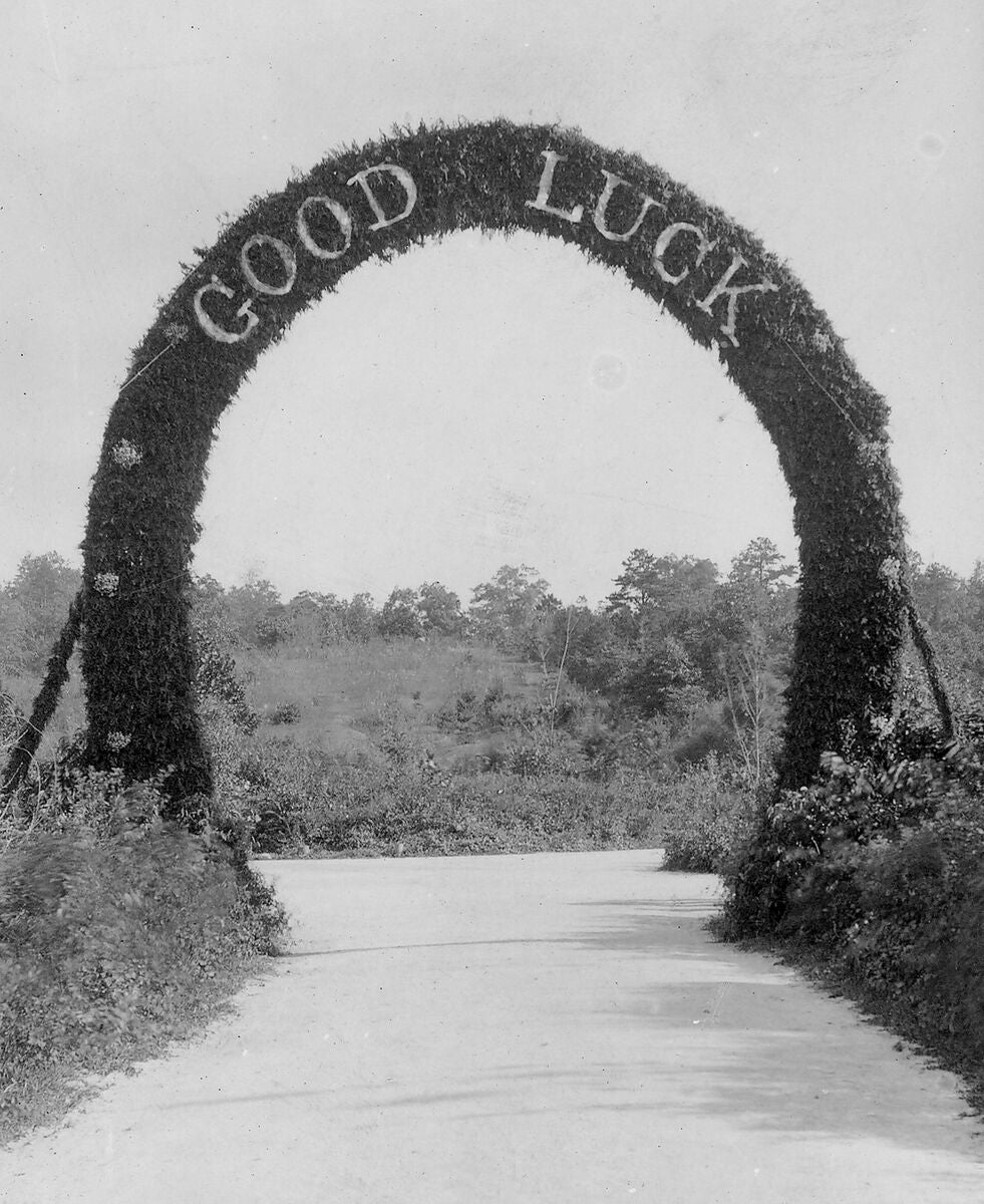 Archival photograph of the floral arch constructed by estate employees to welcome home the newlyweds.