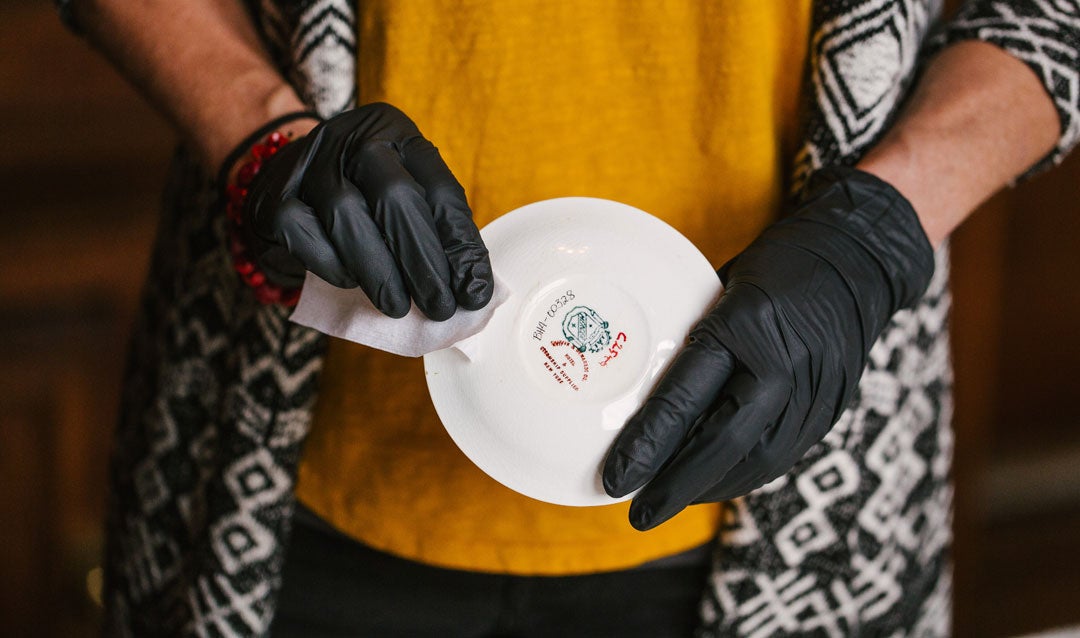 Biltmore conservator shows manufacturer's mark on the bottom of a china saucer