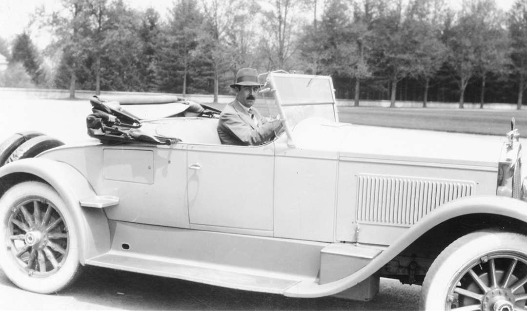 John Cecil driving in front of Biltmore House