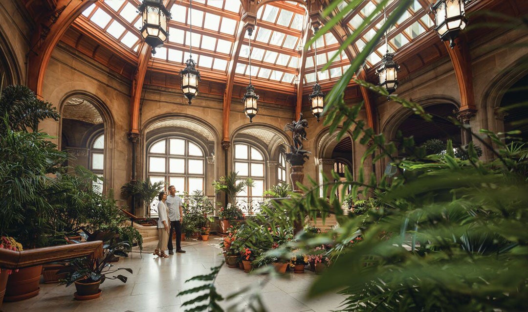 Couple views Winter Garden in Biltmore House