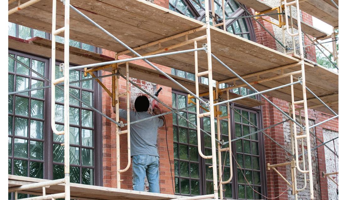 Man working on a scaffold on the exterior of Biltmore's Conservatory