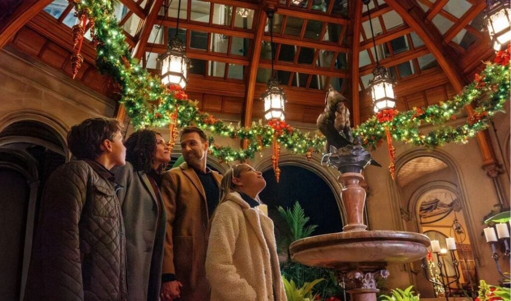 A family enjoys the Christmas decor in the Winter Garden of BIltmore House