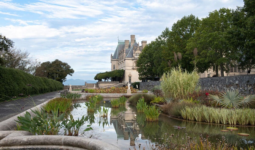 View of Biltmore House reflecting off the Italian Garden pools in the Fall