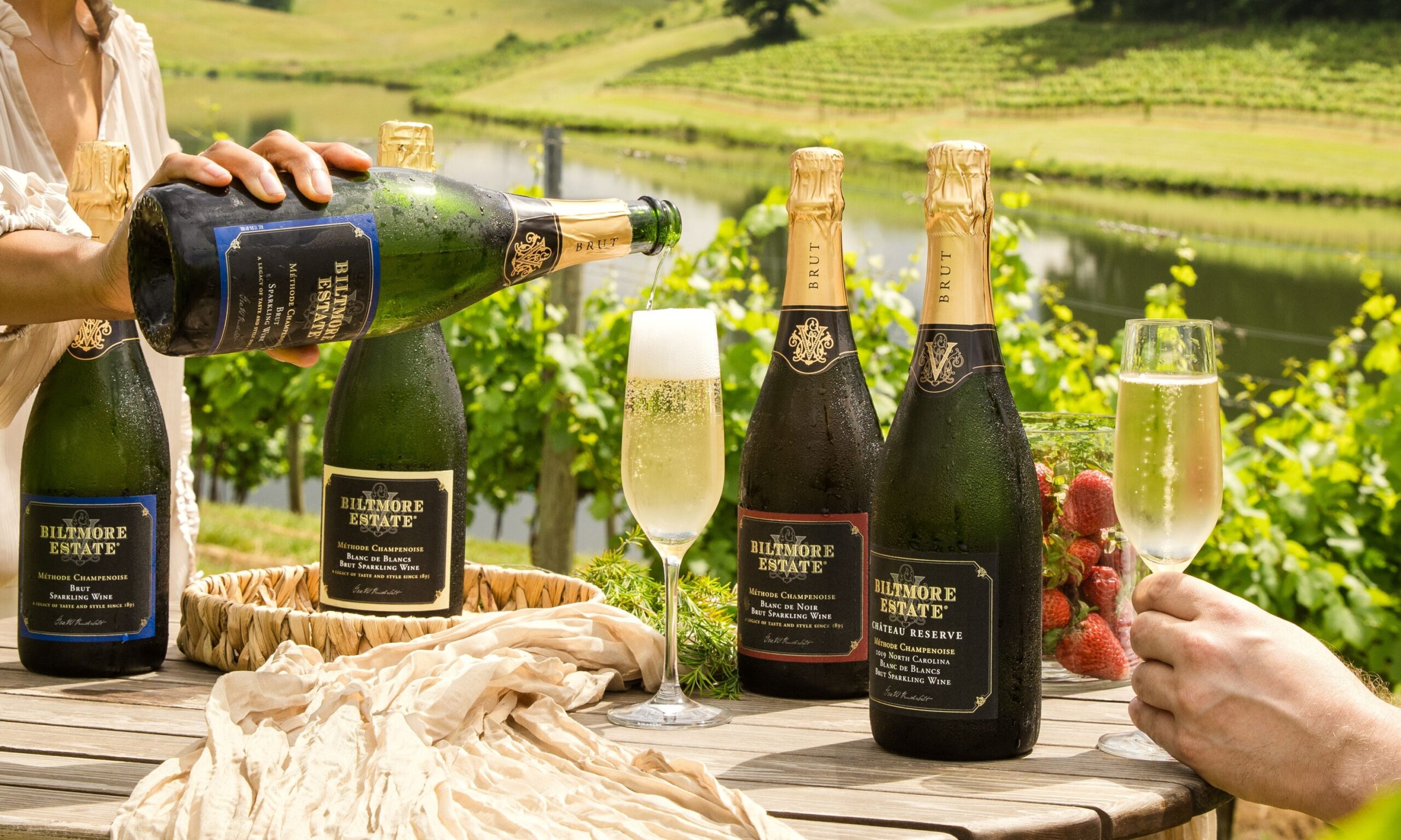 Biltmore Estate sparkling wines being poured in a vineyard during a summer white party.