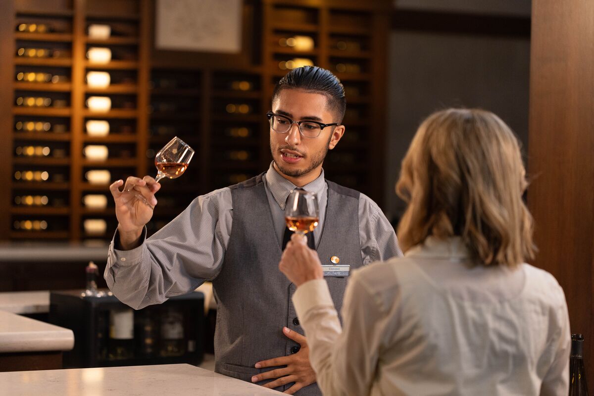 Biltmore Winery host offers Biltmore Rosé wine to a guest.