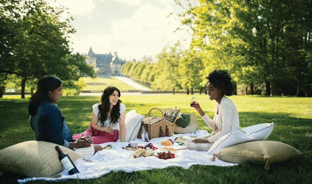 Ladies enjoying a warm weather picnic with wine at Biltmore House