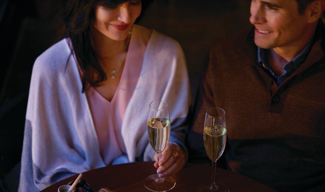 Couple drinking winter wines while they savor in place at home