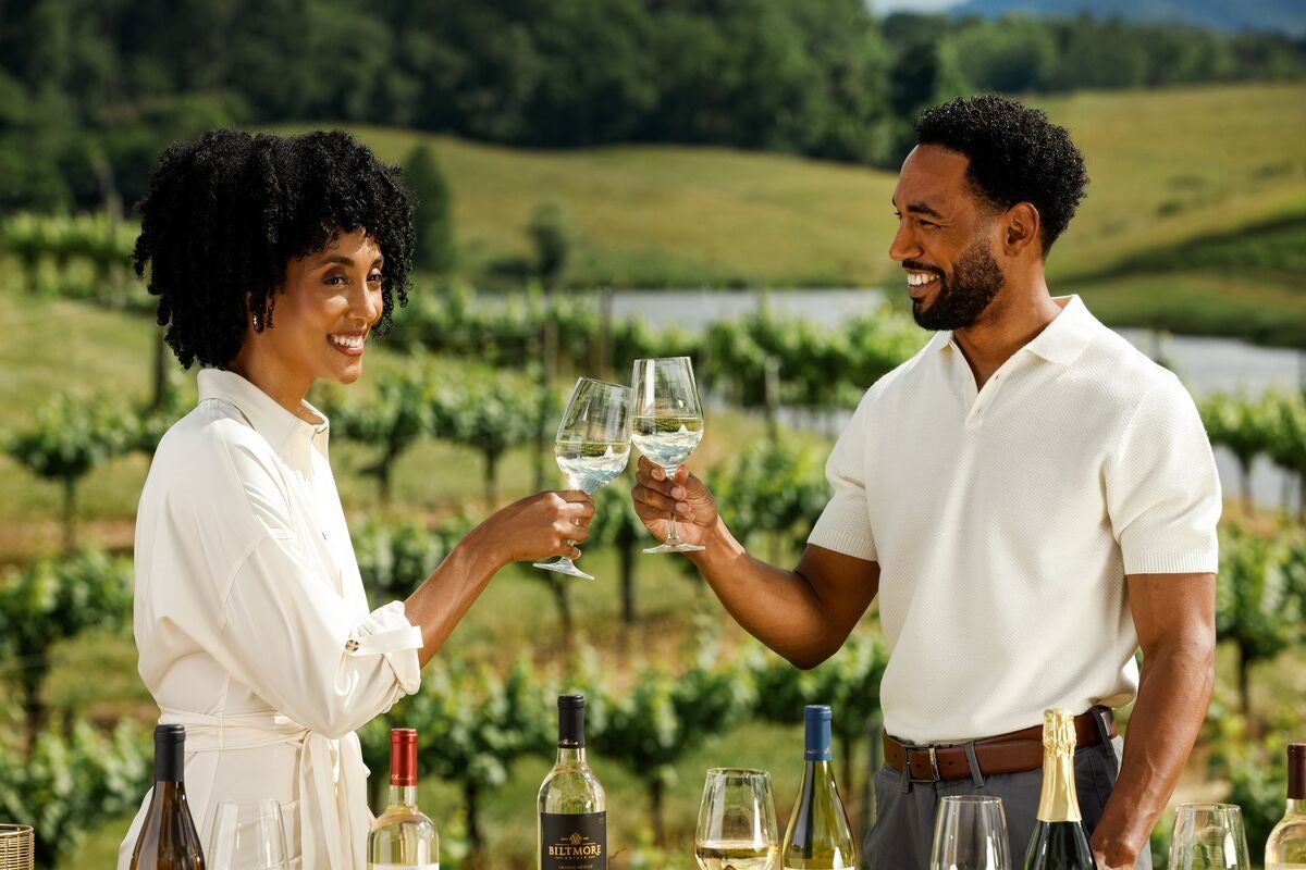 Couple in vineyard savors summer with Biltmore Estate Limited Release white wine.