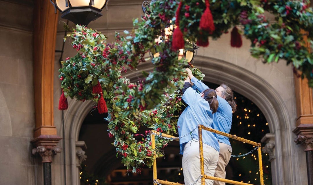 Floral team members install garland