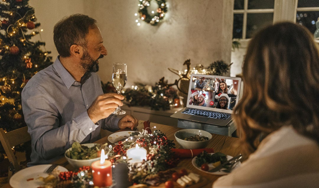 Couple video chatting with friends during Christmas dinner