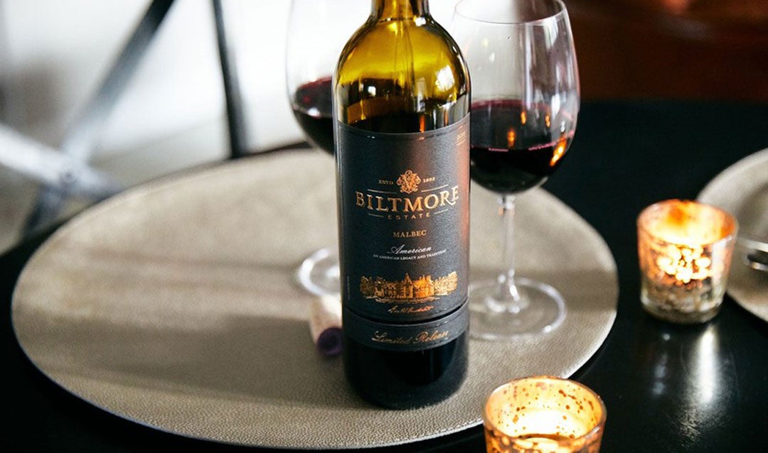Biltmore Estate® Limited Release Malbec on a tray with candles