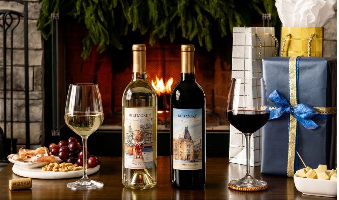 Bottles and glasses of Biltmore Masterpiece Collection Christmas Wines with presents.
