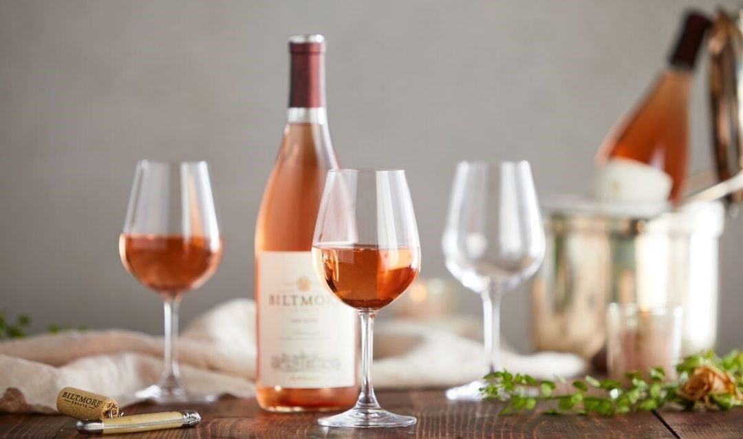 Bottles of Biltmore Estate Dry Rosé and several glasses.