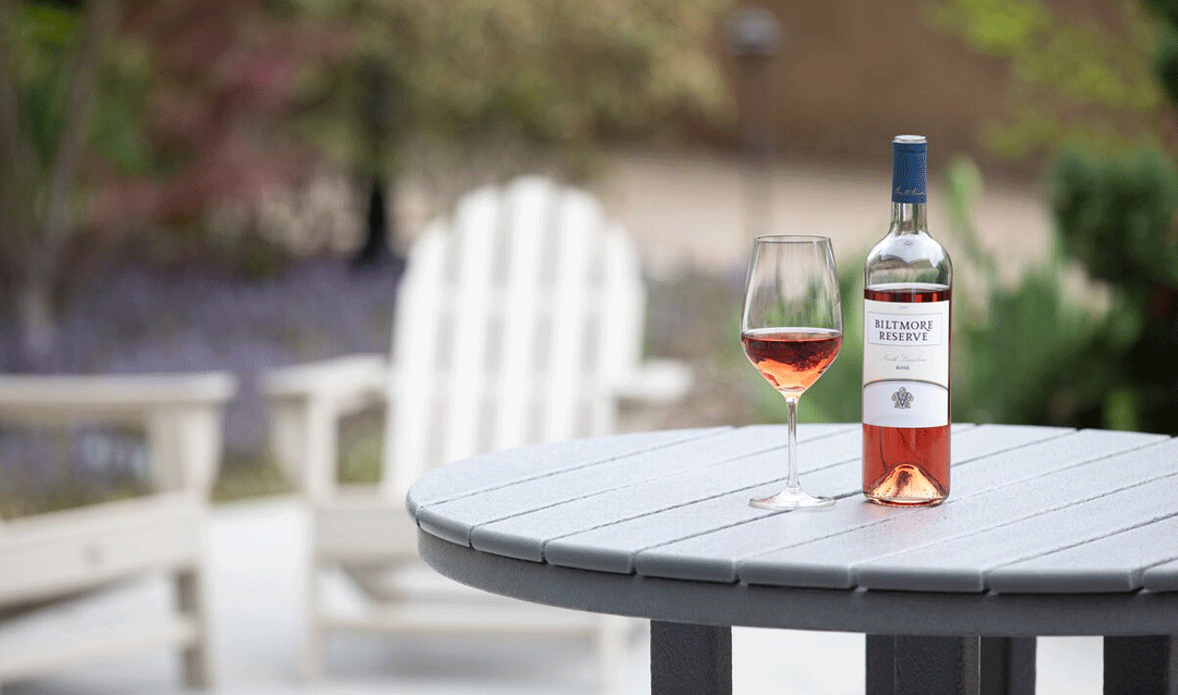 Glass and bottle of Biltmore Reserve North Carolina Rosé wine on an outdoor table