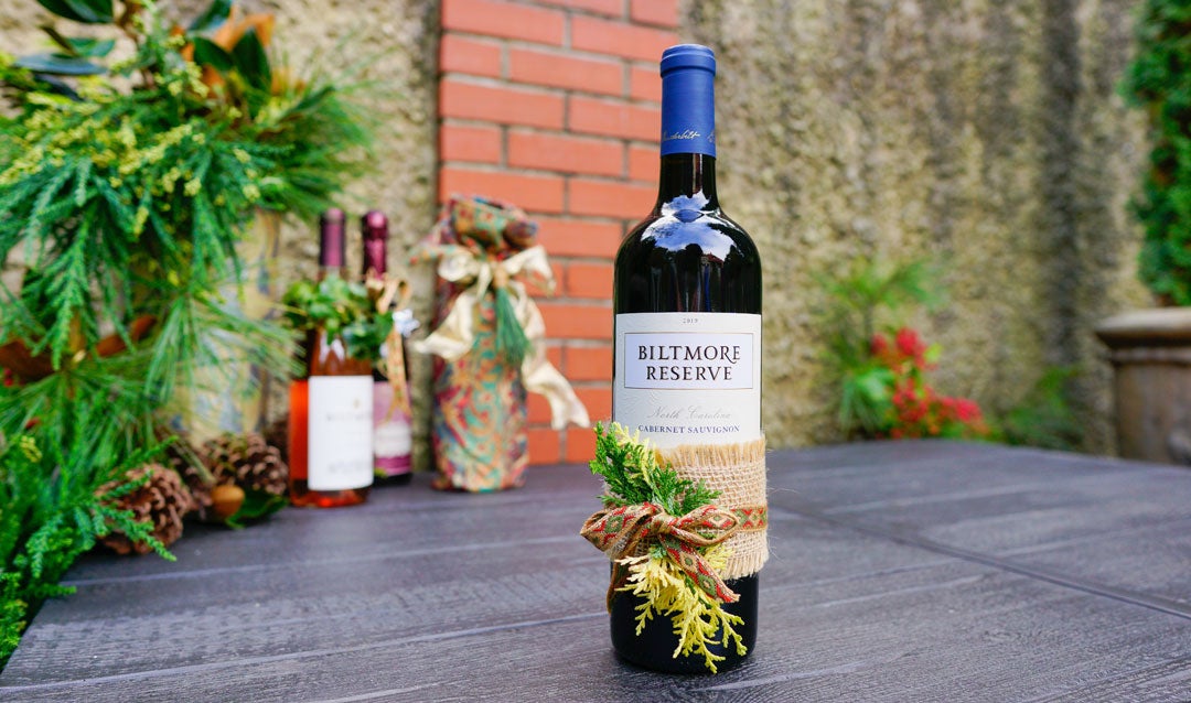 Biltmore Reserve Cabernet Sauvignon wrapped with a ribbon and greenery
