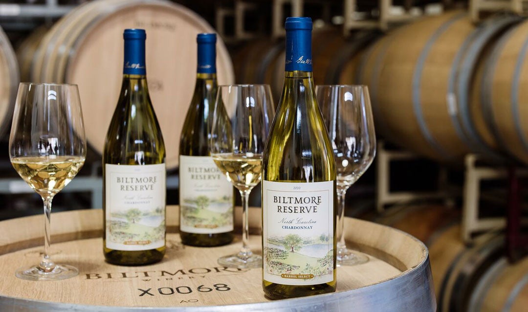 Bottles of Biltmore Reserve Chardonnay sitting on a barrel