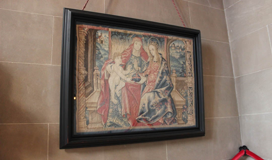 Framed tapestry displayed on the first landing of the Grand Staircase in Biltmore House