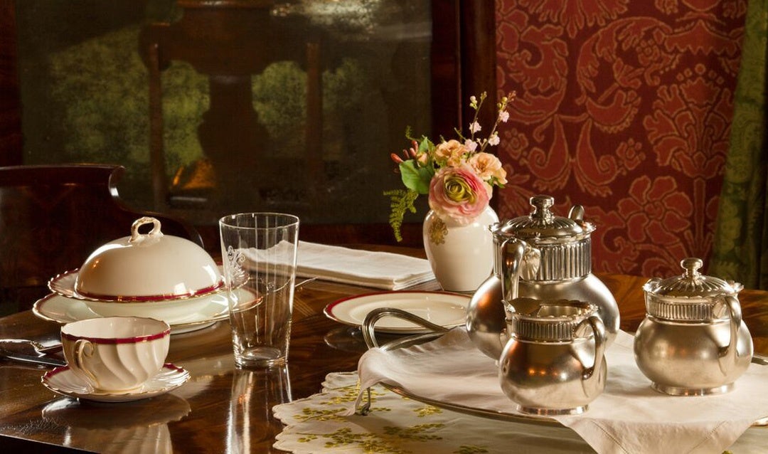 On display in the Damask Room is a breakfast setup including Vanderbilt china, demonstrating that guests could choose to have breakfast in their rooms if preferred.