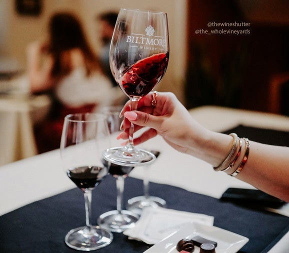 UGC image of hand swirling red wine in Biltmore wine glass