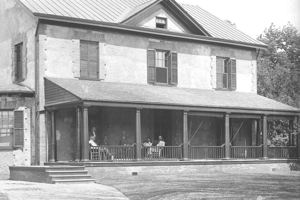 Richard Morris Hunt (seated, far left), George Vanderbilt (center), purchasing agent Edward Burnett (far right) and unidentified others at the Alexander House, where George Vanderbilt stayed when he visited the estate during the construction era, circa 1893