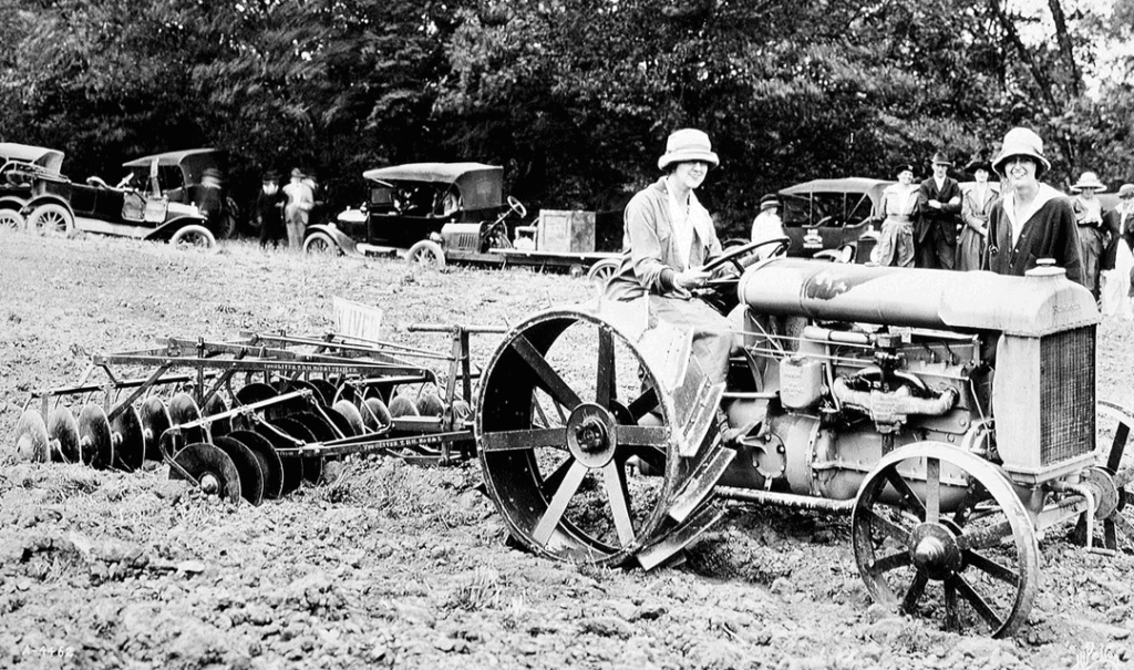Farm history: archival image of Edith and Cornelia Vanderbilt with a tractor