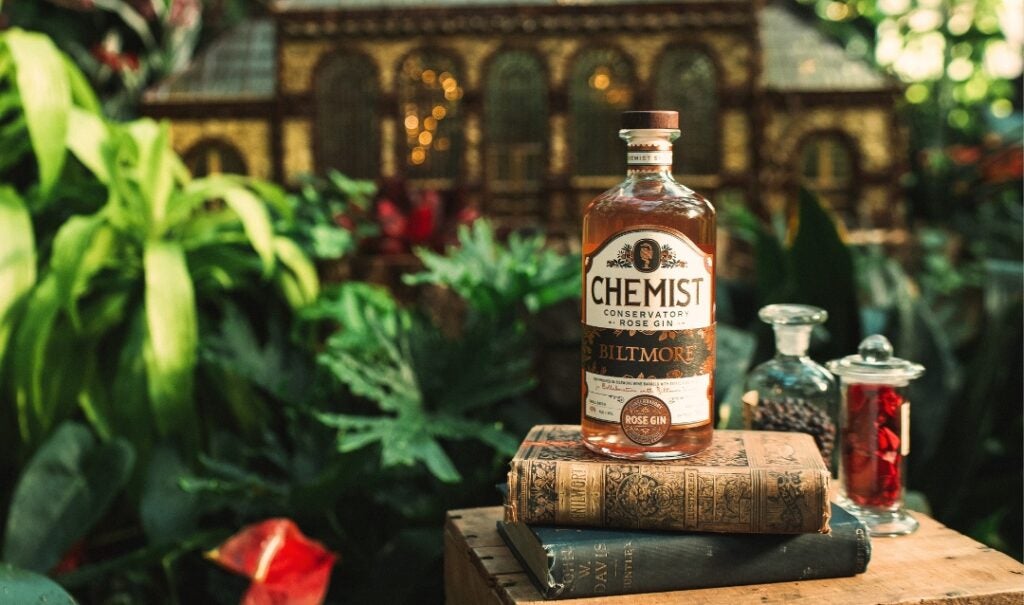 A bottle of Biltmore Conservatory Rose Gin on a stack of books.