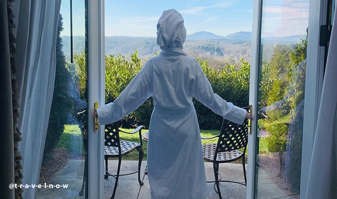Woman in a bathrobe admiring the view at The Inn on Biltmore Estate