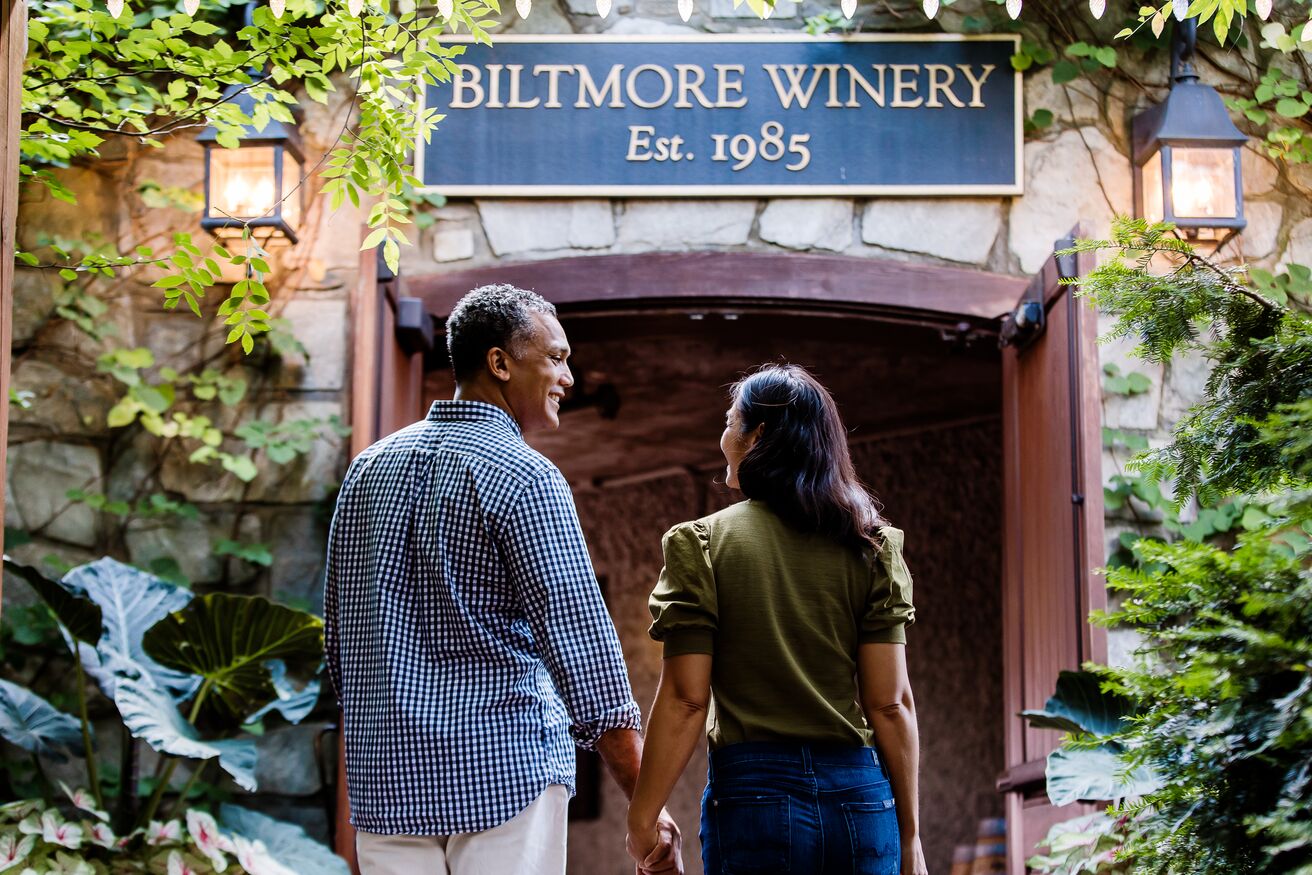 A couple walks hand-in-hand as they approach the entrance to Biltmore's Winery.