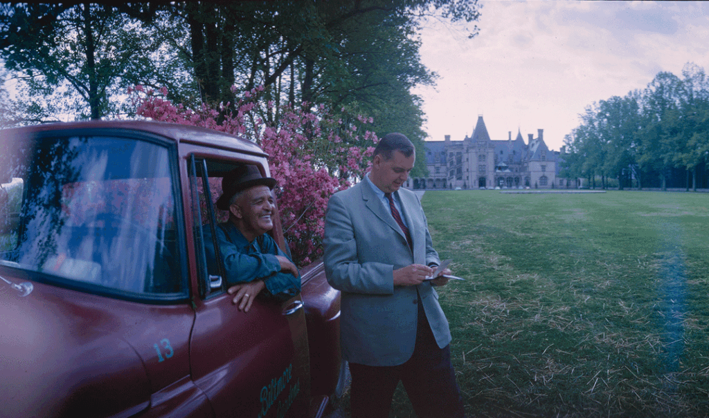Sylvester Owens and William Cecil with a truck in front of Biltmore House