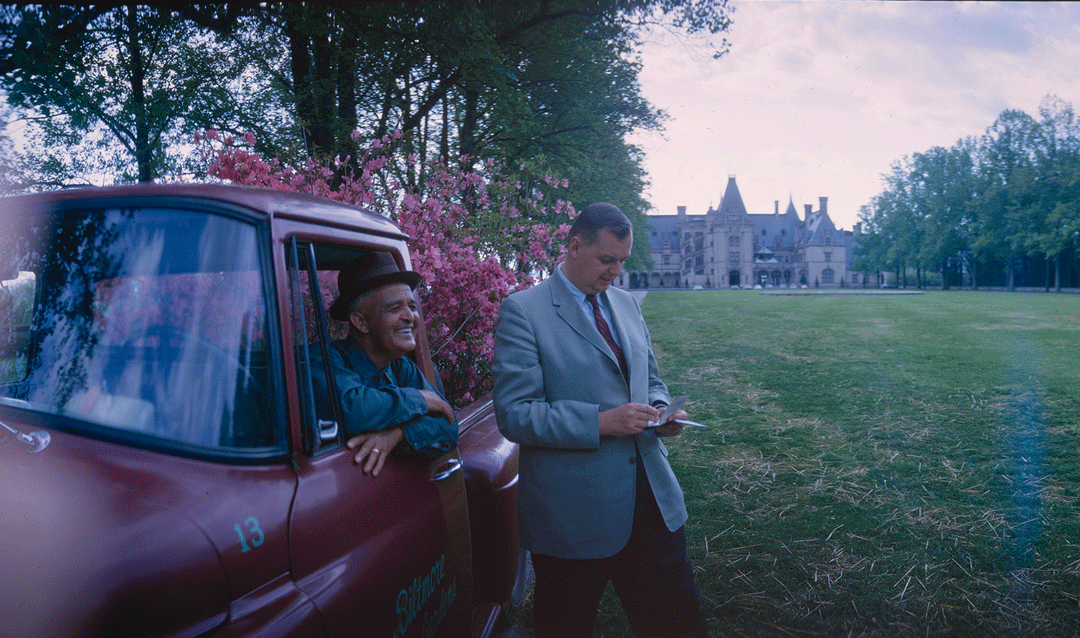 Sylvester Owens and William Cecil with a truck in front of Biltmore House