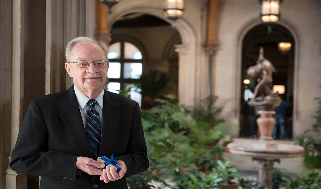 Fred Cothran proudly holds the keepsake cake from the Vanderbilt-Cecil wedding.