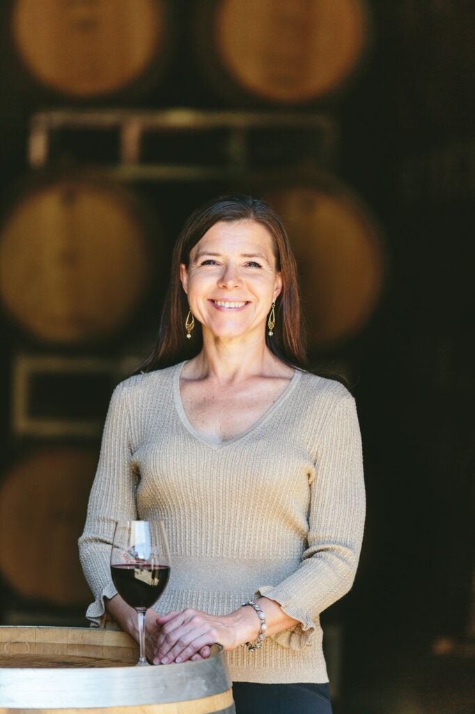 Sharon Fenchak, Biltmore winemaker, with wine barrels in background