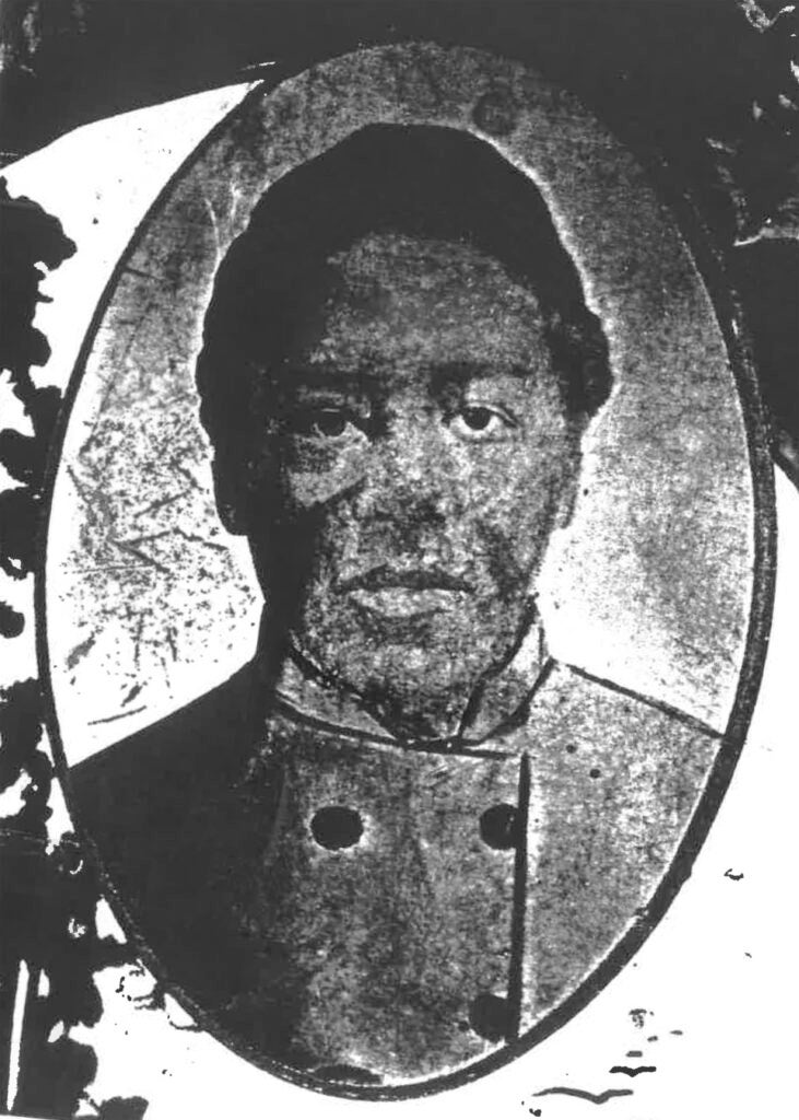 William Logan (a black man) poses for a portrait in an overcoat.
