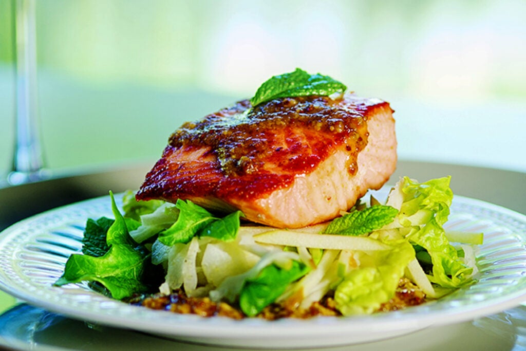 Slow-roasted salmon atop curry mustard and apple-fennel salad