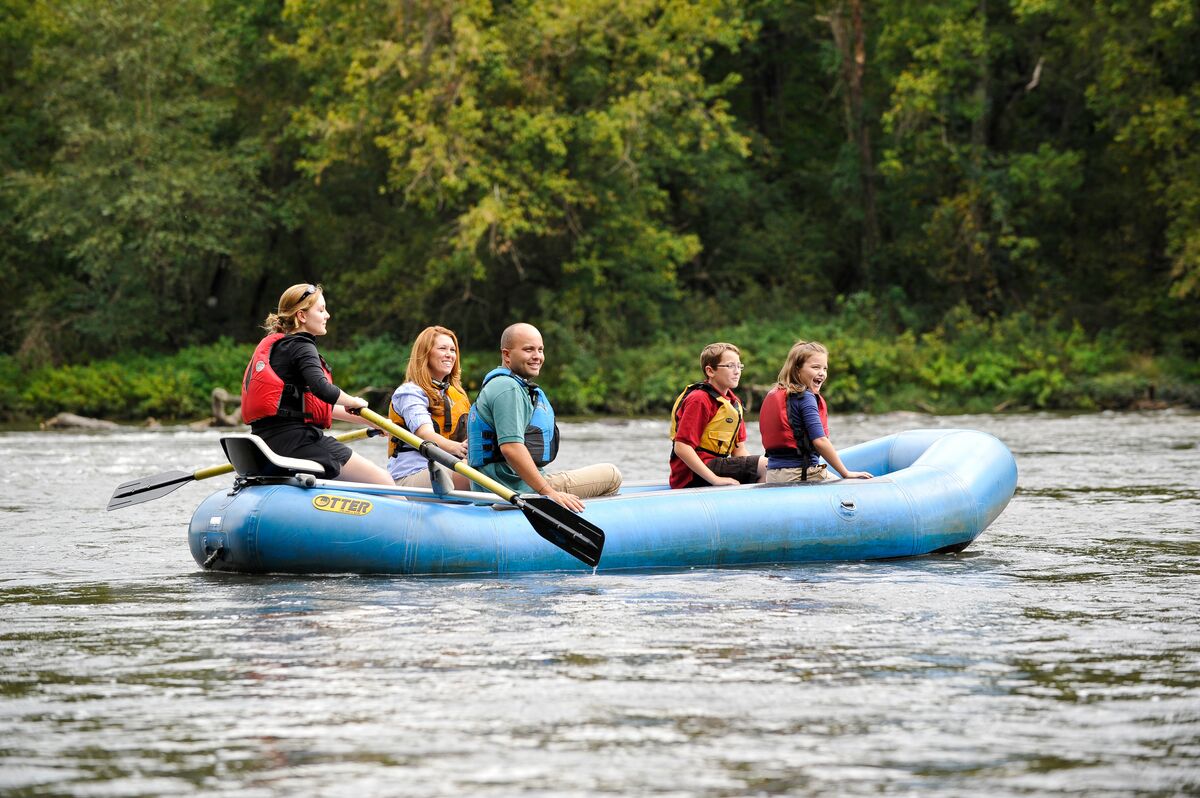 Family of four enjoys a river float with a guide.