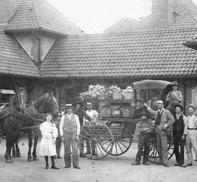 Archival image of Biltmore employees and estate residents at the Market Gardener's Cottage