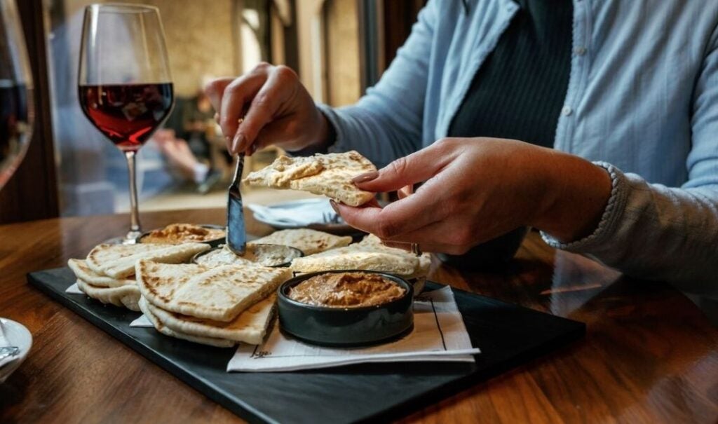 Hummus and pita slices paired with a glass of red Biltmore wine at the Biltmore Estate Winery Wine Bar
