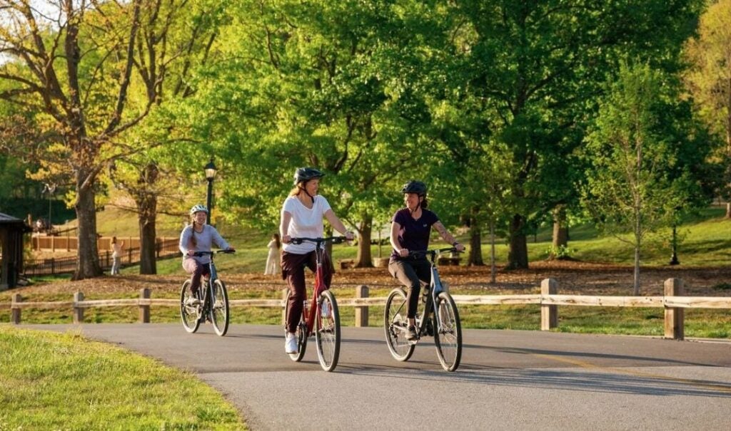 Outdoor adventures: Three women riding bikes near Antler Hill Village at Biltmore.