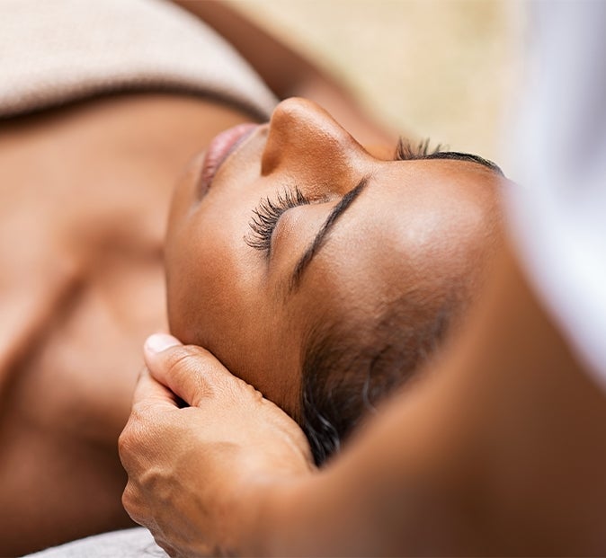 Woman enjoys facial at spa