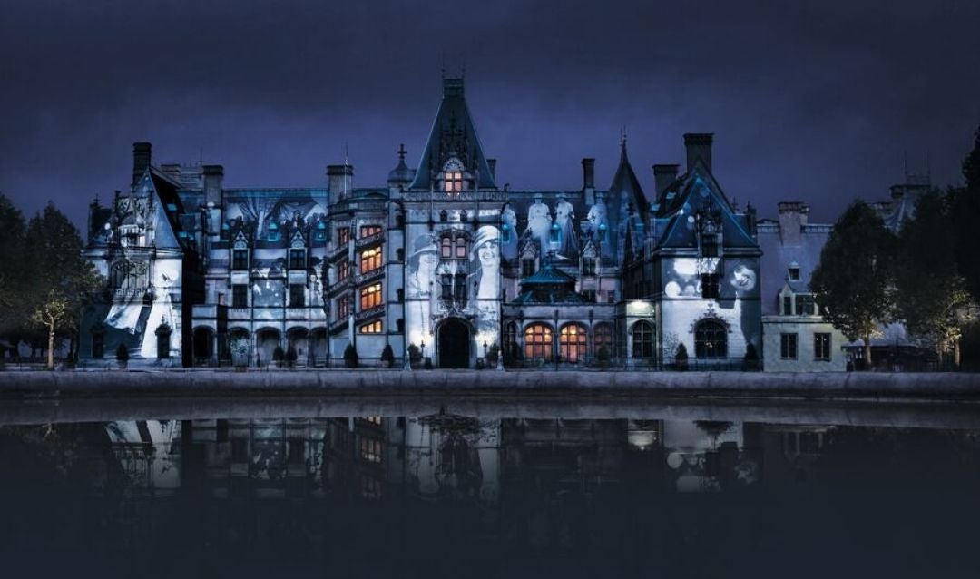 Facade of Biltmore House at night with Luminere show.