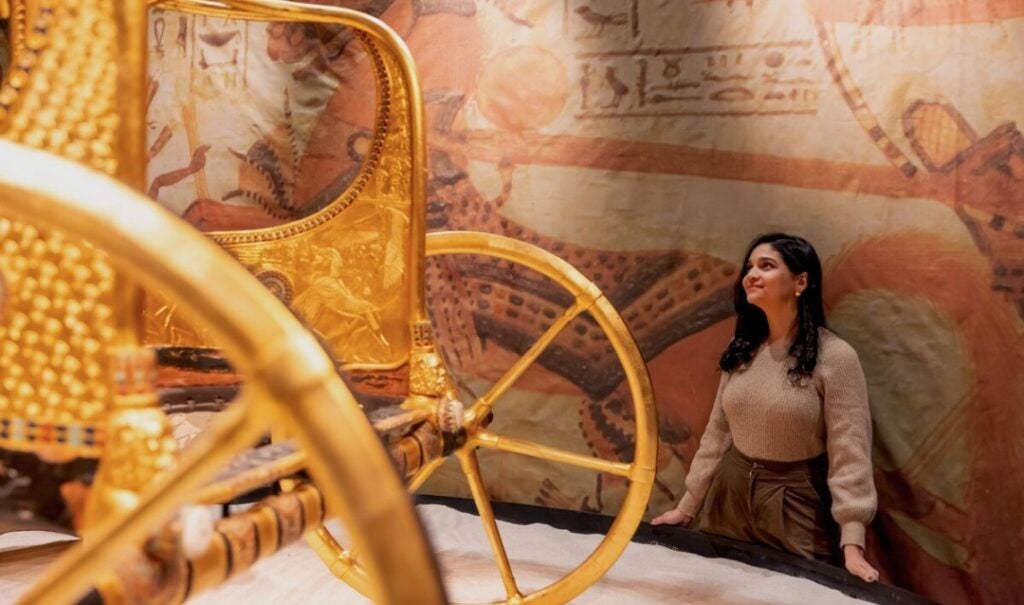 Woman views the chariot of King Tut at Biltmore.