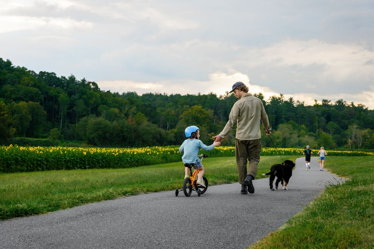 Family walks along trail in Antler Hill Village