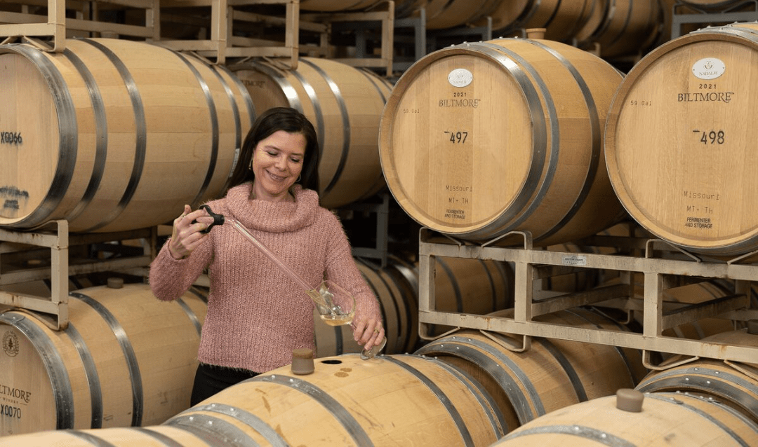Winemaker Sharon Fenchak uses a wine thief syphon in the Barrel Room at Biltmore Winery.