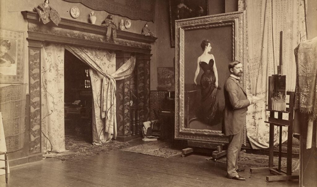 Archival photograph of John Singer Sargent in his studio with the portrait of Madame X.