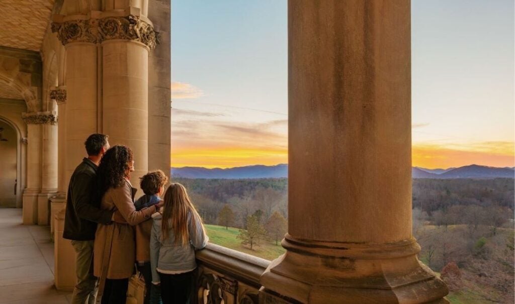 Family looks out at the view from the Loggia of Biltmore House