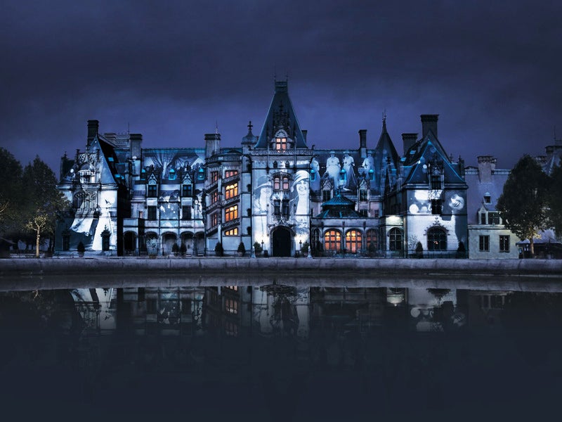 Biltmore House at night with historical photo projected on facade