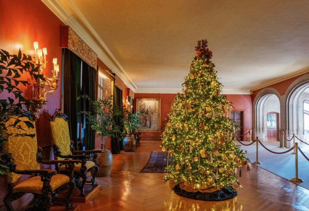 Christmas trees and holiday decor in the Second Floor Living Hall of Biltmore House.