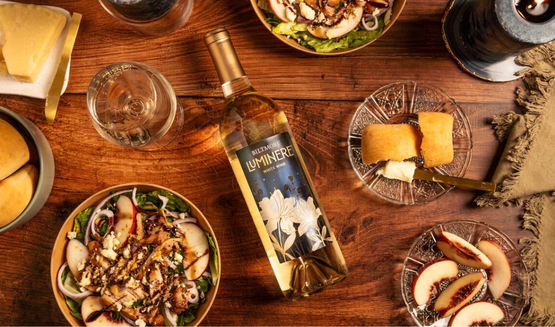 Luminere White Wine on a table with food.