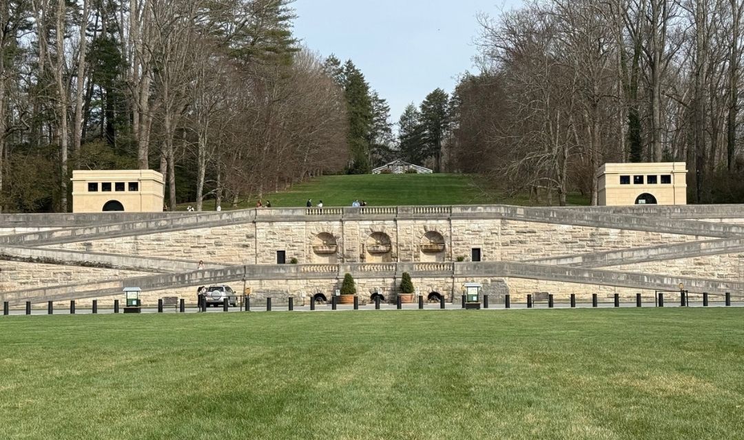 Two small buildings on either end of the Front Lawn retaining wall at Biltmore.