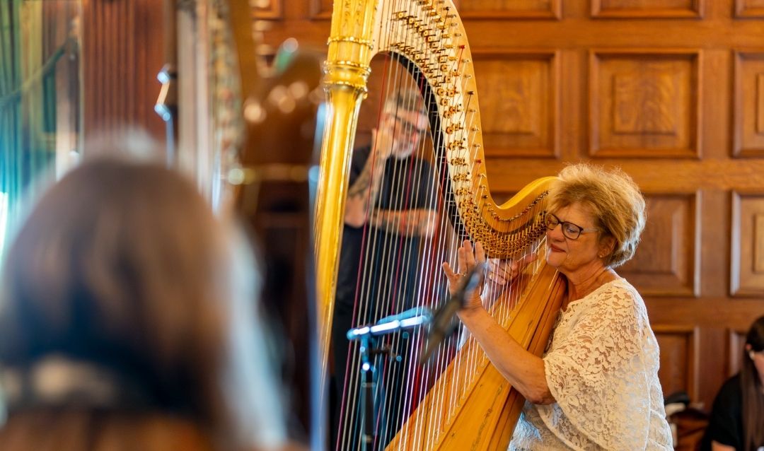 Woman playing a harp.